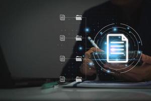 Document management system concept, business man using tablet search folder and document icon software, searching and managing files online document database, for efficient archiving and company data. photo