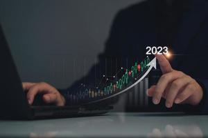 Digital marketing 2023 goals. Businessman analyzing internet marketing online, 2023 business planning, business skyrocket, online stock market analysis, stock chart next year, digital stock trading photo