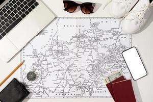 traveler accessories with map, devices and clothes on white background photo