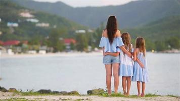 Beautiful mother and her adorable little daughters on the beach video