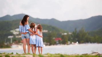 Beautiful mother and her adorable little daughters on the beach video