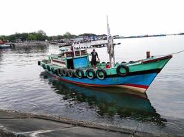 Probolinggo,Indonesia. November,06,2022-fisherman with boat photo