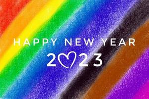 HAPPY NEW YEAR 2023 on blurred hand drawing rainbow colors background, concept for greeting invitation card and happy new year 2023 concept. photo