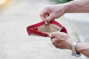 Closeup senior' man hands open empty wallet. Concept, no money, economic crisis. Financial problems. photo