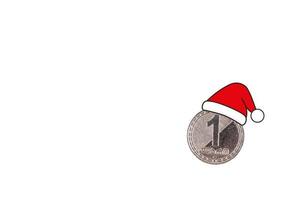 Metal coin, denomination, one Lari Georgia in a Santa Claus hat. White isolated background. photo