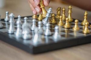 The company is businessman is hands move chess on the game plan to win the business in the market. concept of leadership photo