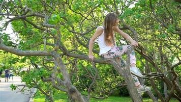 Cute girl in blooming apple tree garden enjoy the warm day video