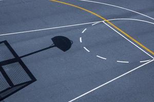 street basketballl hoop shadow on the sports court photo