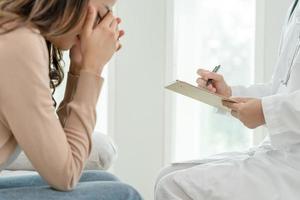 woman with mental health problems is consulting. psychiatrist is recording the patient's condition for treatment. encouragement, love and family problem, bipolar , depression patient, protect suicide photo