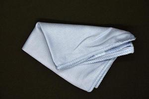 Light blue cloth for wiping.  Towel on a black background. photo