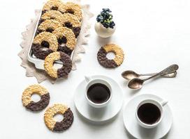 Chocolate cookies with two cups of coffee photo