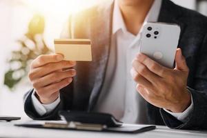 Close up of woman hand using credit card and laptop for payment and online shopping, Online shopping, payments digital banking, E-commerce concept. photo