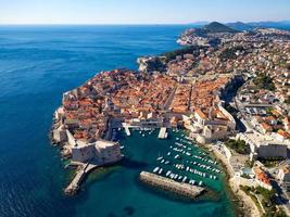 Aerial drone view of the Old historic city of Dubrovnik in Croatia, UNESCO World Heritage site. Famous tourist attraction in the Adriatic Sea. Fortified old city. Tourism and travel to Croatia. photo