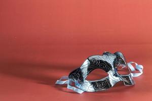 Venetian carnival mask, forming frame in one of the lower corners with space for text photo