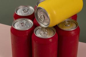 Cold red soda cans with a yellow one for conceptual use photo