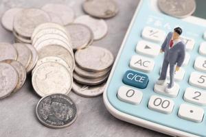 Miniature people are on calculator businessman finance business concept photo