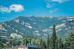 Picturesque beautiful mountains against the blue clear sky. City in the mountains in summer. Life in nature photo