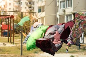 Provincial residents dry clothes and belongings on the street. Blankets and sheets on the bar. Life of the villagers photo