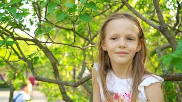 Cute girl in blooming apple tree garden enjoy the warm day video