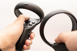 Samutprakarn Thailand Jan 23 2023 oculus rift touch controller on hand isolated on white background. Oculus Quest 2 virtual reality headset controllers. photo