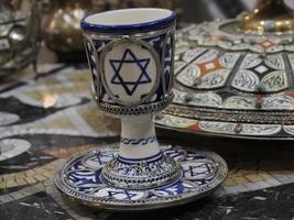 jewish Moroccan Craftsman painting and decorating ceramic products in pottery factory in Fez, Morocco photo