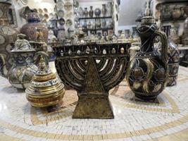 jewish Moroccan Craftsman painting and decorating ceramic products in pottery factory in Fez, Morocco photo