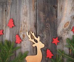 green branches of spruce, wooden toy deer photo