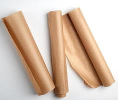 three rolled rolls of parchment baking paper photo