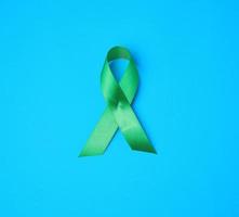 green ribbon as a symbol of early research and disease control, symbol of Lyme disease photo