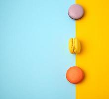 multi-colored baked round macarons on a colored background photo