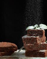 stack of square baked brownie chocolate cake slices photo