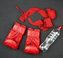 pair of red leather boxing gloves, textile bandage for bandaging the athlete's hands photo