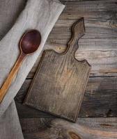 old brown wooden spoon and cutting board photo