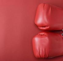 pair of red leather boxing gloves on a red background, photo