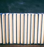 many books on a brown wooden table photo