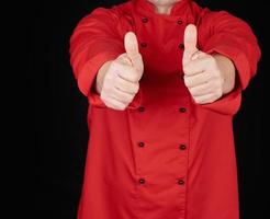 cook in red uniform stretched his arms forward and shows gesture like photo