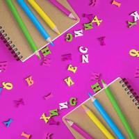 two notebook and multicolored wooden pencils photo