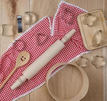 wooden sieve, rolling pin and other kitchen items on the board photo