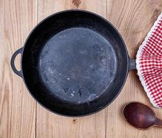 empty black round frying pan and red kitchen napkin photo