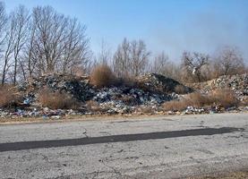 unauthorized garbage dump along the road photo