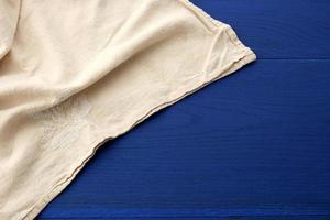white kitchen textile towel folded on a blue wooden table from boards photo