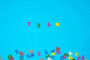 word team of multi-colored letters on a blue background photo