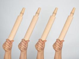 hands hold kitchen wooden rolling pins photo