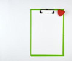 paper clipboard and red heart on a white background photo