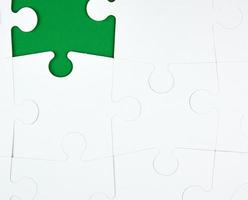 blank white big puzzles on green background, copy space photo