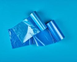 blue plastic bag for garbage on a blue background photo