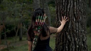 A Woman touching the big tree with her hands video