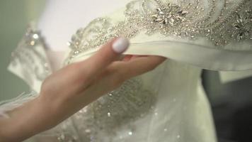 de bruid houdt een bruiloft jurk in haar handen video