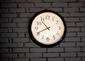 large dial wall clock brick wall background. photo
