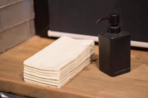 stack paper towels hands and liquid soap dispenser photo